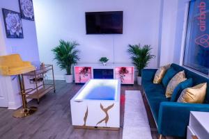 a living room with a blue couch and a table at Luxurious 2 Bedroom Downtown City Views! in Indianapolis
