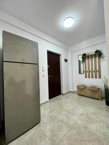 a large room with a refrigerator and a door at Trippin Iasi Apartament in Iaşi