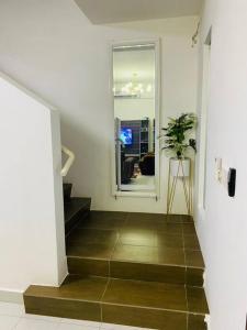 萬津的住宿－Afrinas Homestay @ Banting，走廊上设有楼梯,有窗户和植物