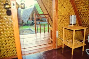 a room with a glass door leading to a porch at HIRAYA Camp Site - FREE use of SCOOTER must have a VALID driving LICENSE in El Nido