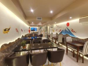 a conference room with chairs and a table and a wall at Saigon By Night Luxury Hotel in Ho Chi Minh City