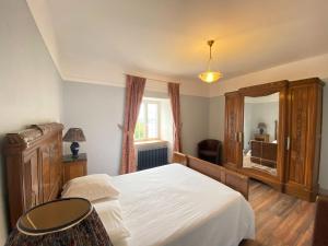 a bedroom with a bed and a large mirror at Comfortable holiday apartment on the 2nd floor of an elegant manor house in Coutances