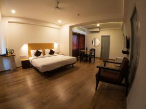 a hotel room with a bed and a table at Hotel B R REGENCY in Trivandrum