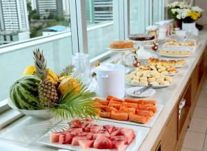 a buffet of food with fruits and vegetables on a table at Iguatemi Business & Flat by Avectur in Salvador