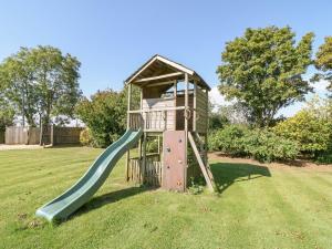 a playground with a slide in the grass at The Clealings in Witney