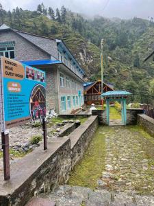 a building with a sign in front of it at Kongde Peak Guest House in Phakding