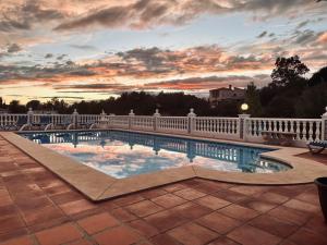 a swimming pool on a balcony with a sunset at Casa Hermosa Mijas in Mijas