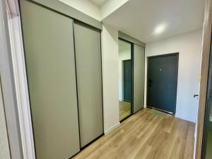 a hallway with sliding glass doors and wood floors at Exclusive USA Embassy Proximity Apartments in Ulaanbaatar