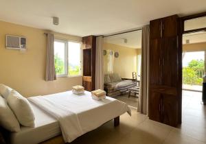 a bedroom with a bed with two candles on it at Boracay Amor Apartment in Boracay +95 photos