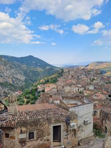 a view of a town with mountains in the background at B&B Vatra in Civita