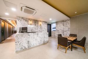 a dining room with a marble wall at Sloth Hotel Gimhae in Gimhae