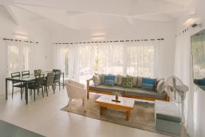 a living room with a couch and a table at Villa Aurora Siargao- Villa 1 in General Luna