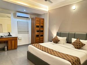 a bedroom with a large bed and a bathroom at Nexstay Kassaba Inn in Kozhikode