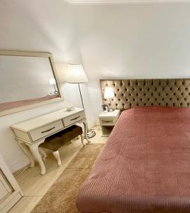 a hotel room with a bed and a mirror at Vintage De Lux, Top Location, 2Bdr Grand Monastery, Pamporovo in Pamporovo