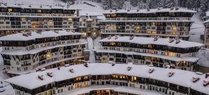 a group of apartment buildings covered in snow at Vintage De Lux, Top Location, 2Bdr Grand Monastery, Pamporovo in Pamporovo