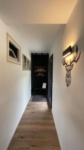a hallway with a wall with a deer head on the wall at Le Chalet de la Plage in Sévrier