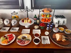 a table with many plates of food on it at Ballina Manor Boutique Hotel in Ballina