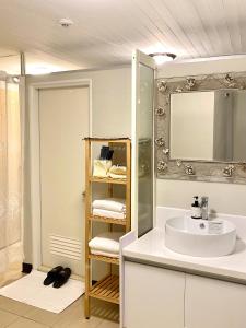 a bathroom with a sink and a mirror at 寵物友善九份沐石原宿一館包棟民宿MU SHI BnB兩人即包棟 in Ruifang