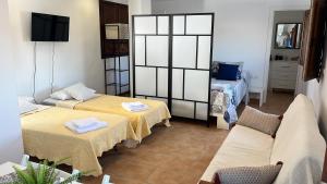A bed or beds in a room at Apartamento Flor