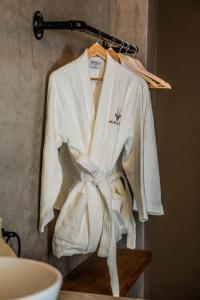 a robe hanging on a rack in a bathroom at Minara Private Boutique Game Lodge in Dinokeng Game Reserve