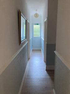 a hallway with a door and a window and a hallwayngthngthngthngthngth at The ideal retreat for some vitamin sea! in Sandgate