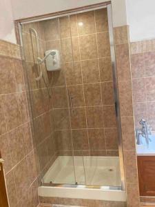 a shower with a glass door in a bathroom at The ideal retreat for some vitamin sea! in Sandgate