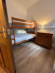 a bedroom with two bunk beds and a dresser at The ideal retreat for some vitamin sea! in Sandgate
