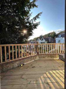 a wooden deck with a fence and a bench at The ideal retreat for some vitamin sea! in Sandgate