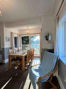 a dining room with a table and chairs and a window at The ideal retreat for some vitamin sea! in Sandgate