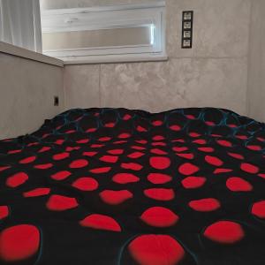 a room with a bed with red hearts on it at Hurmioru guesthouse near Otepää with sauna in Hurmi