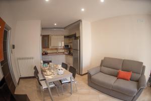 a living room with a couch and a table at Salerno4Seasons in Salerno