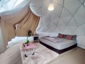 a bedroom with a bed in a large tent at ภูชวนหลง ม่อนแจ่ม in Chiang Mai +9 photos