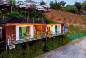 a row of houses on the side of a hill at ภูชวนหลง ม่อนแจ่ม in Chiang Mai