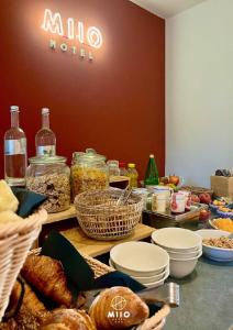a table with baskets of bread and other food at MIIO HOTEL in San Vincenzo