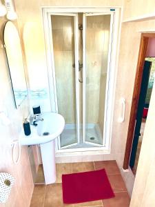 a bathroom with a sink and a shower at Apartment with hot tub and stunning views in Oria in Oria