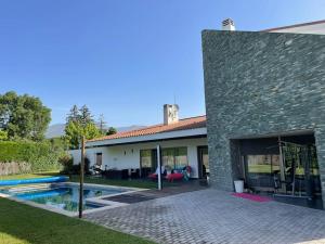 una casa con piscina frente a ella en Magnífica Casa Familiar en Moralzarzal Madrid, en Moralzarzal