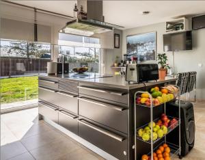 a kitchen with a bunch of fruits on a shelf at Magnífica Casa Familiar en Moralzarzal Madrid in Moralzarzal