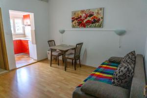 a living room with a couch and a table at Apartments Petrica in Baška