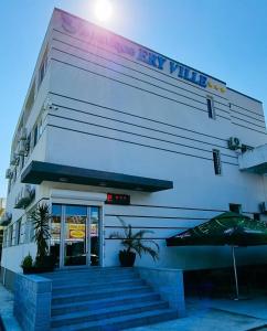 a white building with stairs in front of it at Ery Ville Neptun in Neptun