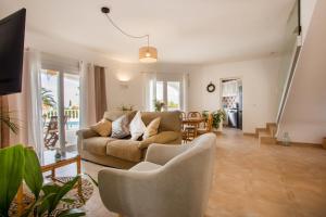 a living room with a couch and chairs at Villa Joanna in Son Bou