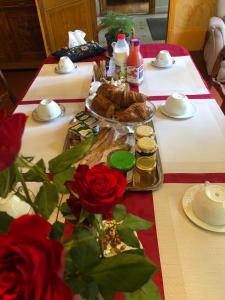 a table with food and roses on it at Demeure des Payratons in Saint-Gérand-le-Puy +29 photos