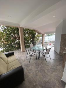 a living room with a couch and a table and chairs at Magnolia Guest House in K'obulet'i +14 photos