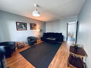 a living room with a couch and a table at STAY Matinkatu Apartment in Espoo