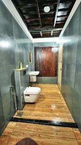 een badkamer met een toilet en een wastafel bij Gypsea Marari in Alleppey
