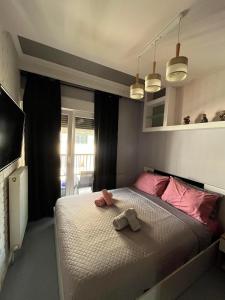 a bedroom with a bed with two towels on it at VIP Apt. Pezodromos Kalamarias in Thessaloniki