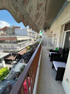 a balcony of a building with a view of a city at VIP Apt. Pezodromos Kalamarias in Thessaloniki