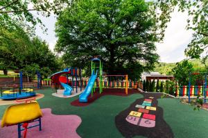 a playground with a slide in a park at 3 Stejari Brasov in Braşov