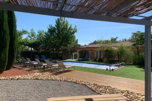a patio with chairs and a swimming pool at LAcacia in Plaissan