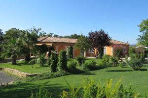 a house with a yard with grass and trees at LAcacia in Plaissan +14 photos