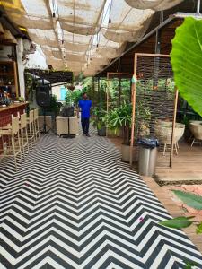 a man walking on a black and white floor at South Delhi restaurant and resort in Vagator